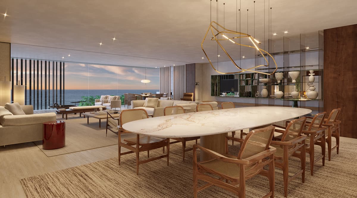 Sala de jantar decorada com mesa de mármore e vista para o mar